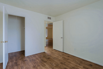 A room with white walls and wooden floors with a large closet at Sahuaro West, Phoenix Arizona